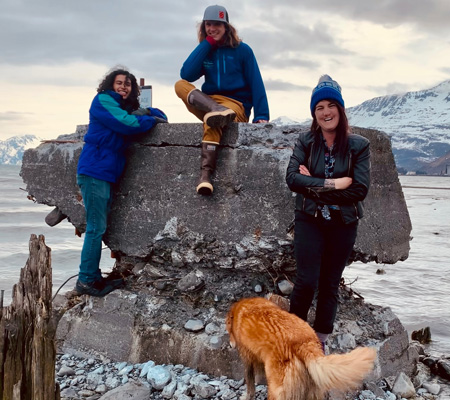 Residence life staff at Prince William Sound College stand on a beach in Valdez, Alaska