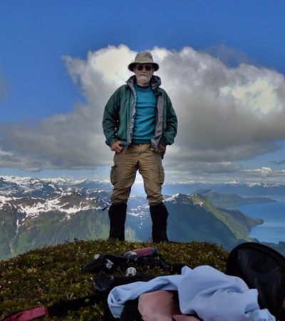 Paul May on top of a peak in Prince William Sound, Alaska
