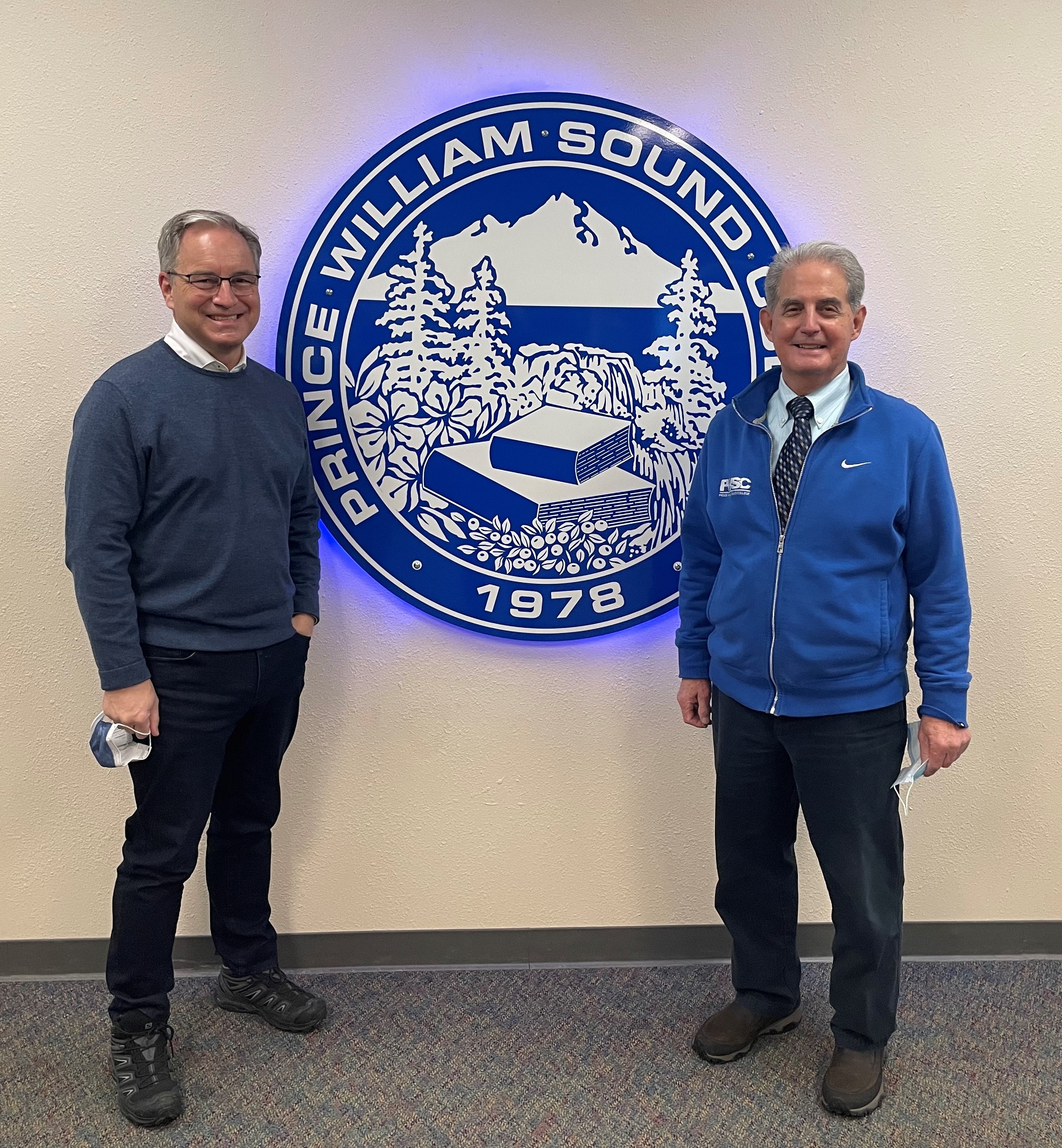 Chancellor Parnell and Director O'Connor standing in front of PWSC Seal