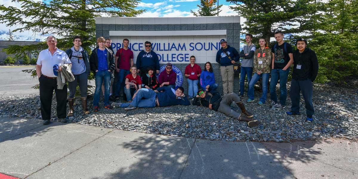 Alaska Tech Learners 2019 participants in front of a Prince William Sound College sign