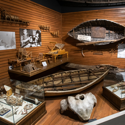 Wooden boat hanging on a wall. 