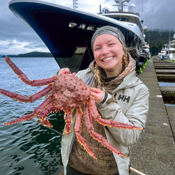 Girl holding a crab. 