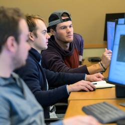 Students looking at a computer screen. 
