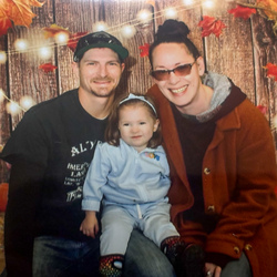 Family photo of father, mother and child.