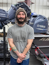 Student in front of a Yamaha outboard engine. 