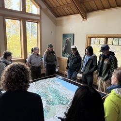 Group of people gathered around a map.