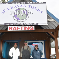 Three people standing in front of Pangaea Adventures building. 