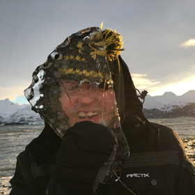 Ryan Belnap holds up sea ice in Valdez, Alaska