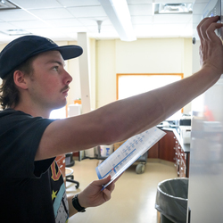 A student looking at stats on a board.