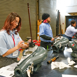 Studetns working on outboard engines.