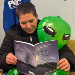 Girl reading book with an alien. 