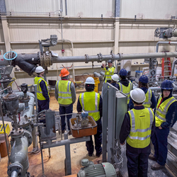 Group of people in maintenance area.