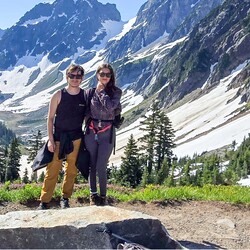 A man and woman outside in the mountains. 
