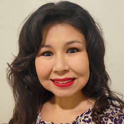 Woman smiling facing camera.