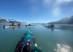Several kayaks in the ocean. 