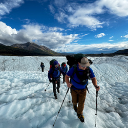 Students climbing on a mountain with snow and ice. 