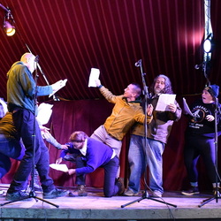 Group of people on stage acting. 