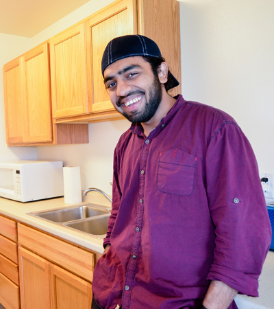 Junaid in the kitchen of a student apartment at Prince William Sound College in Valdez, Alaska.